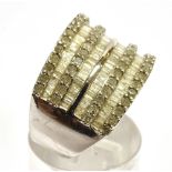 A DIAMOND SET EIGHT ROW SILVER RING the front section comprising alternating rows of small round