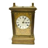 A BRASS CASED 8-DAY CARRIAGE CLOCK the enamel dial with Roman numerals, movement chiming on a coiled