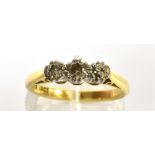 A DIAMOND THREE STONE RING the round brilliants approx. 0.60cts, claw set in white, on a yellow '