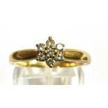 A DIAMOND FLOWERHEAD CLUSTER 9 CARAT GOLD RING cluster comprising seven round brilliant cut