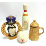 FOUR NOVELTY DECANTERS by Jim Beam and Old St. Andrews, each with contents.