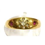 A c1900 DIAMOND AND RUBY SET 18CT GOLD BAND RING the front inset with a small diamond flower head