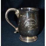 A SILVER PRESENTATION MUG the plain baluster form with scroll handles on pedestal base,