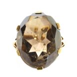 A SMOKY QUARTZ SINGLE STONE 9CT GOLD DRESS RING the large oval cut smoky quartz measuring approx.