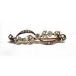 AN EDWARDIAN DIAMOND SET BAR BROOCH the garland style front comprising leaf and scroll design, rub