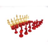 A STAUNTON PATTERN BONE CHESS SET natural white and stained red, the kings 75mm high (one