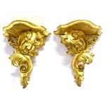 A PAIR OF CARVED AND GILDED WOODEN WALL BRACKETS in the rococo taste