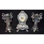 AN ART NOUVEAU STYLE THREE PIECE CLOCK GARNITURE with floral relief decoration, in the manner of