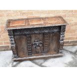 A CONTINENTAL OAK BOX WITH HINGED LID and carved decoration, 91cm wide 34cm deep 64cm high