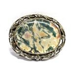 A MOSS AGATE AND SILVER OVAL BROOCH the polished oval piece of moss agate 35mm x 27mm, the silver