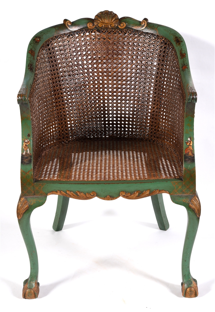 A BERGERE ARMCHAIR with double caned back, the carved frame with green lacquered Chinoiserie