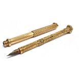 A 19TH CENTURY YELLOW METAL PROPELLING FOUNTAIN PEN AND PENCIL COMBINATION the ornate scroll work