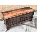 A CONTINENTAL OAK COFFER the front and sides with fielded panels carved with stylised flowers, 114cm