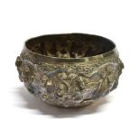 AN INDIAN WHITE METAL BOWL embossed figure scene with floral and leaf borders, 15cm diameter, the