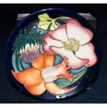 A MOORCROFT POTTERY PIN DISH decorated in the 'Golden Jubilee' pattern, 12cm diameter