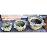 A GRADUATED SET OF THREE STONE MORTARS the largest 54cm wide 26cm high