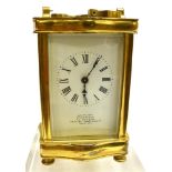 A BRASS CASED CARRIAGE CLOCK the enamelled dial with Roman numerals, inscribed 'J C VICKERY TO THEIR