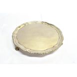 A GEORGIAN SILVER CARD TRAY by Elizabeth Cooke, the three footed tray with gadroon border edge and