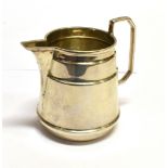 A SMALL SILVER CREAM JUG in the form of a stylised churn, with angled handle, hallmarked