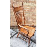 AN ASH AND ELM WINDSOR ARMCHAIR with comb back on spindle turned upright