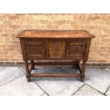 A SMALL 'IPSWICH OAK' SIDEBOARD The front with carved decoration and fitted with pair of doors, on