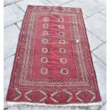 THREE RED GROUND RUGS one with two rows of guls, 110cm x 191cm, another rug 90cm x 165cm, and