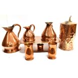 A MIXED LOT OF COPPERWARE comprising three graduated jugs, 25cm, 16cm and 13cm high; a brass burner;