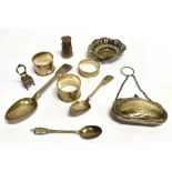AN ASSORTED LOT OF SMALL SILVER ITEMS comprising a finger purse, three napkin rings, a churn