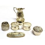 SEVEN SMALL ITEMS OF SILVER comprising a three footed cream jug, with embossed diagonally fluted