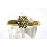A DIAMOND FLOWER HEAD CLUSTER 18 CARAT GOLD RING the flower head cluster comprising seven round