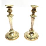 TWO SHEFFIELD PLATE CANDLESTICKS Of same pattern and design, one slightly larger than the other,