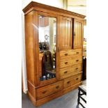 A VICTORIAN ASH COMPACTUM with moulded cornice above mirrored door flanked by cupboard above three