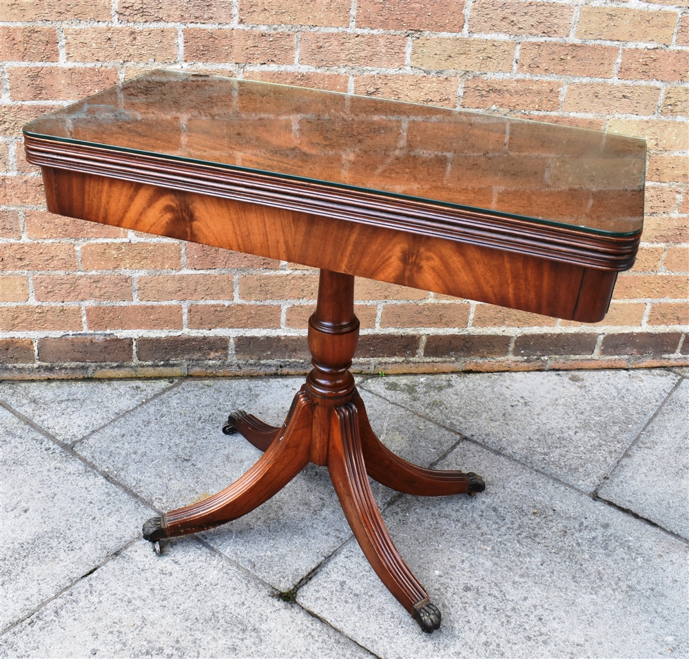 A REPRODUCTION MAHOGANY CARD TABLE on quatrefoil base, 85cm wide