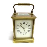 A BRASS CASED CARRIAGE CLOCK the enamelled movement with Roman numerals, the movement stamped '