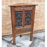 A CARVED OAK CORNER CUPBOARD the doors opening to shaped shelf within, 69cm wide 111cm high