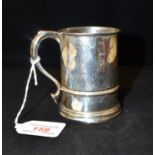 A SMALL SILVER MUG of traditional cylindrical tapered form, with S shaped handle, 9cm high,