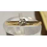 A 9 CARAT GOLD SINGLE STONE DIAMOND RING the brilliant cut of approximately 0.1 carat; with a pair