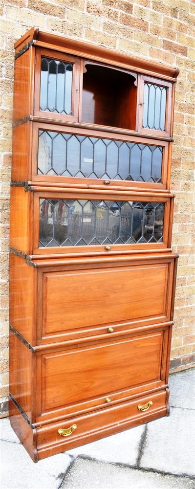 A GOOD GLOBE WERNICKE WATERFALL SECTIONAL BOOKCASE the top tier with open cupboard flanked by pair