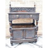 A CARVED OAK BUFFET the top fitted with two drawers with lion mask handles, the base with pair of