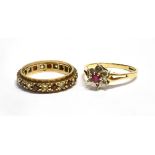 TWO 9CT GOLD DRESS RINGS comprising a small ruby and diamond flower head cluster, ring size L, and a