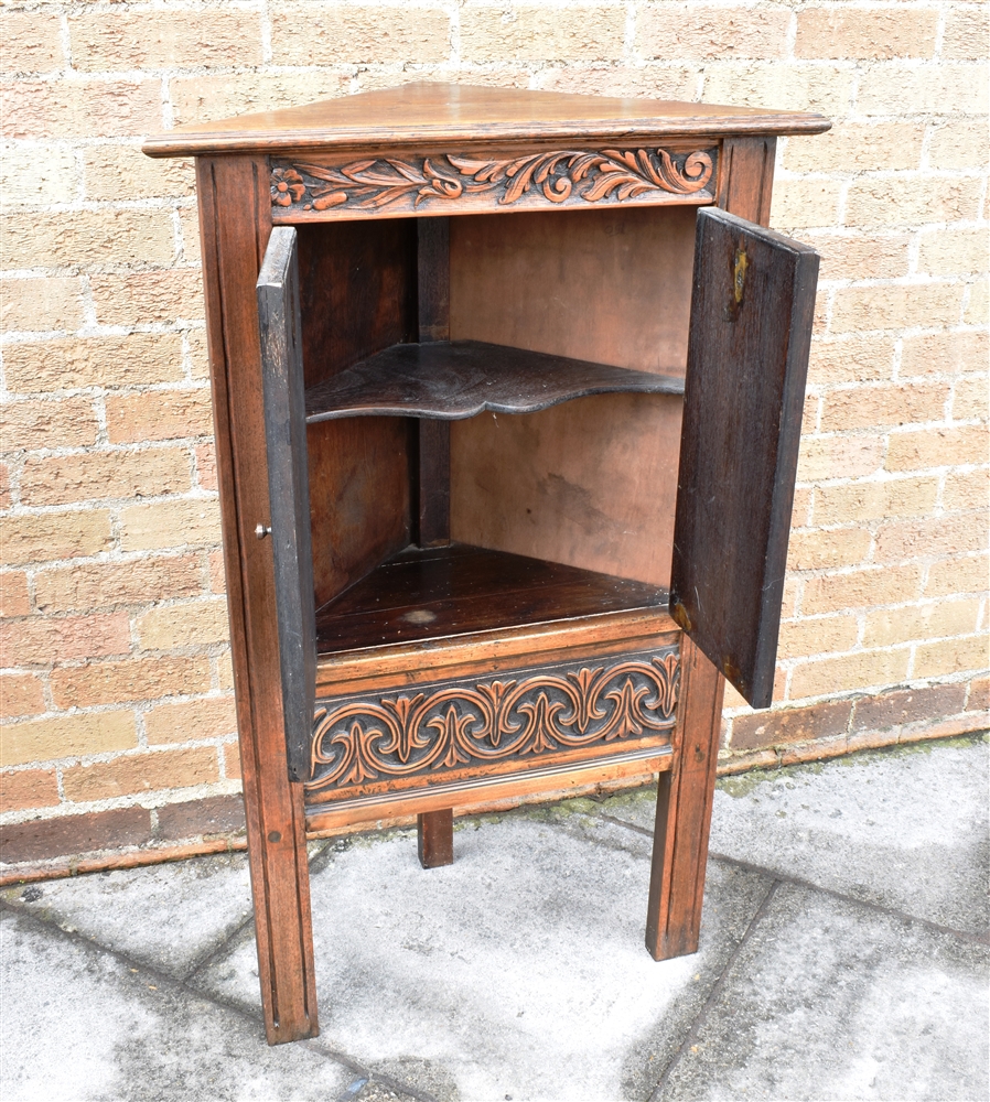 A CARVED OAK CORNER CUPBOARD the doors opening to shaped shelf within, 69cm wide 111cm high - Image 2 of 2