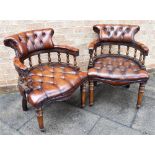 A PAIR OF LEATHER UPHOLSTERED CAPTAINS CHAIRS, the horseshoe shaped backs and serpentine front seats