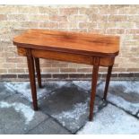 A MAHOGANY TEA TABLE the top with reeded edge, the base with line inlaid decoration and square