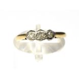 TWO 18CT GOLD RINGS comprising a diamond illusion set three stone ring, the three small round