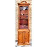 A VICTORIAN OAK SIDE CABINET OF NARROW PROPORTIONS with swan neck pediment and shaped cornice