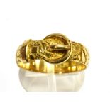 AN 18CT GOLD BUCKLE RING the patterned band of flower head and star pattern design, 5mm wide,