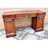 A FIGURED MAHOGANY INVERTED BREAKFRONT SIDEBOARD with carved decoration, 185cm wide 53cm deep 96cm