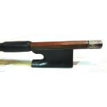 A VIOLIN BOW the stick round, with a silver adjuster and mounts and an ebony frog, the octagonal