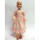 AN ARMAND MARSEILLE BISQUE SOCKET HEAD DOLL with sleeping brown glass eyes, and an open mouth with