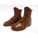 A PAIR OF VICTORIAN CHILD'S BROWN LEATHER BOOTS each with a six-button side fastening and leather